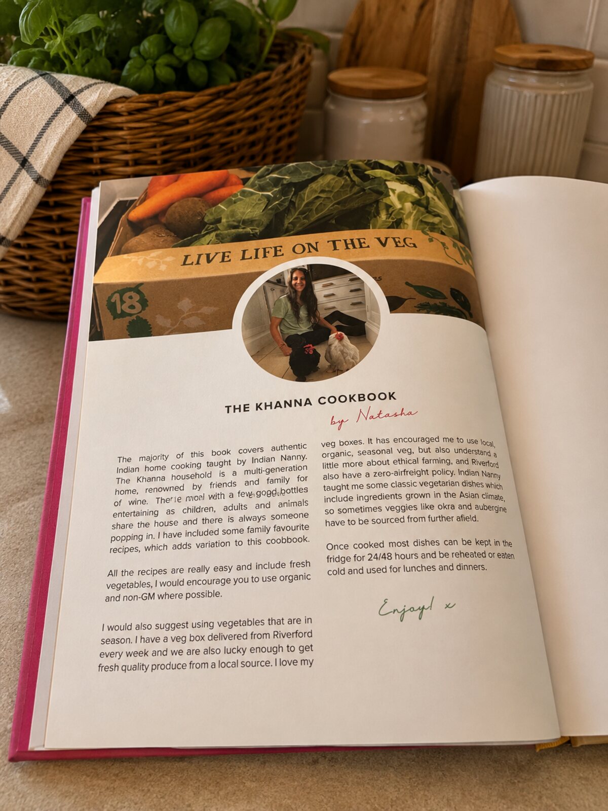 The Khanna Cookbook introduction page by Natasha, with a photo of her and her hens above a box of fresh vegetables